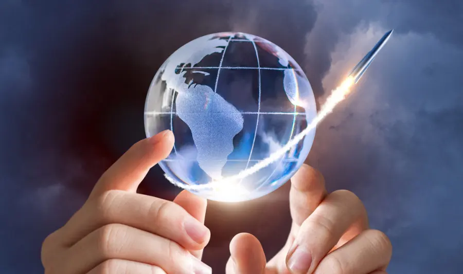 Hand holding a glowing globe, representing international travel